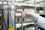 Gloved hand holds test tube in front of machinery