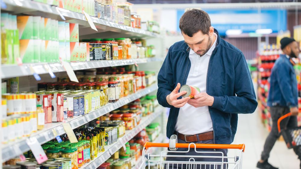 Man reacting to food inflation in supermarket