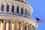 US Congress building dome with US flag flying in foreground