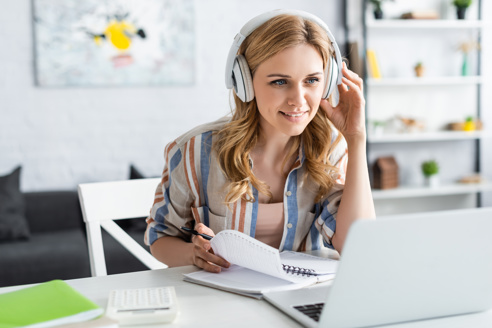 Woman with headphones at computer