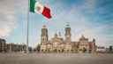Mexican flag in foreground, in front of Mexico's Parliament building